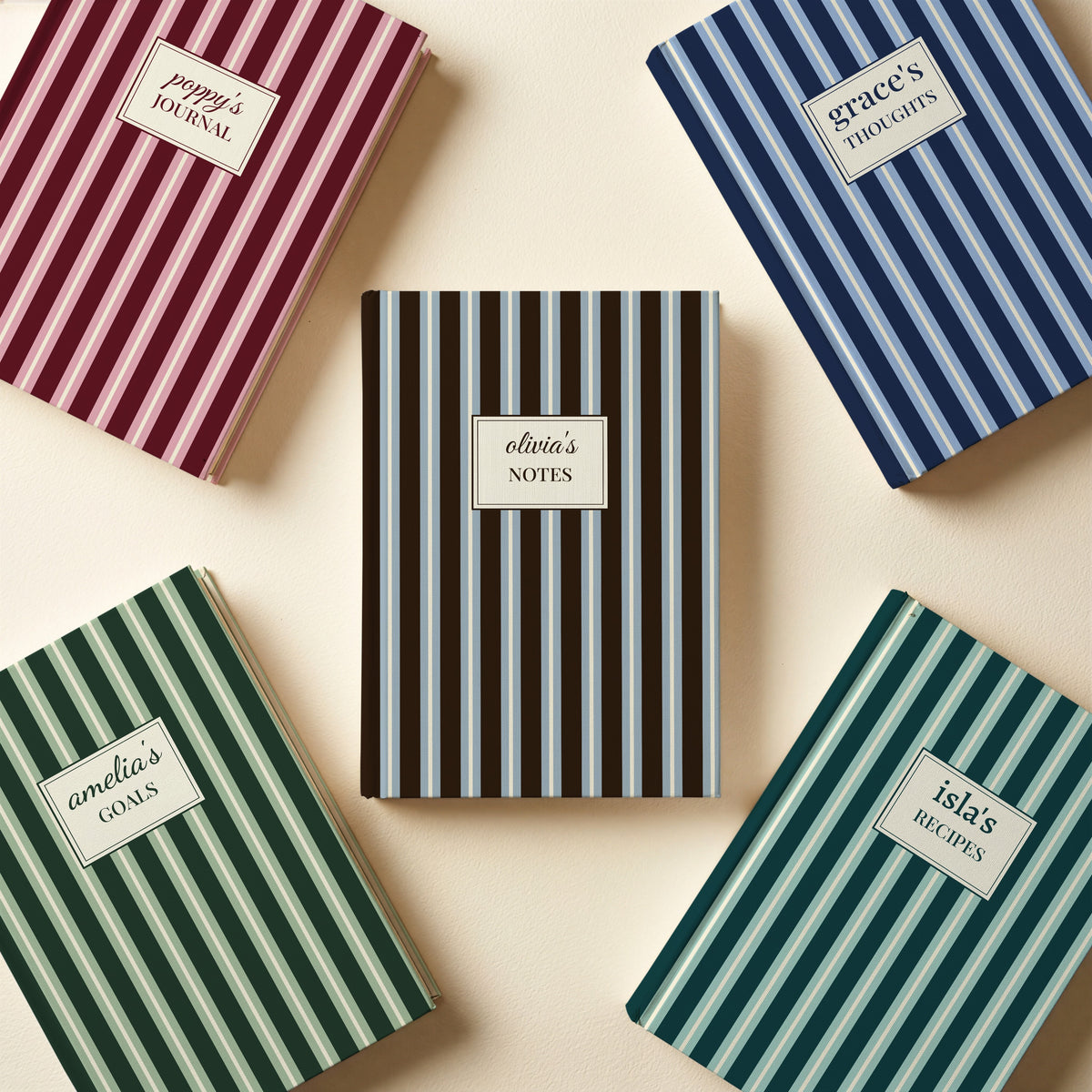 Five personalised striped name label notebooks in chocolate, navy, burgundy, forest green and teal