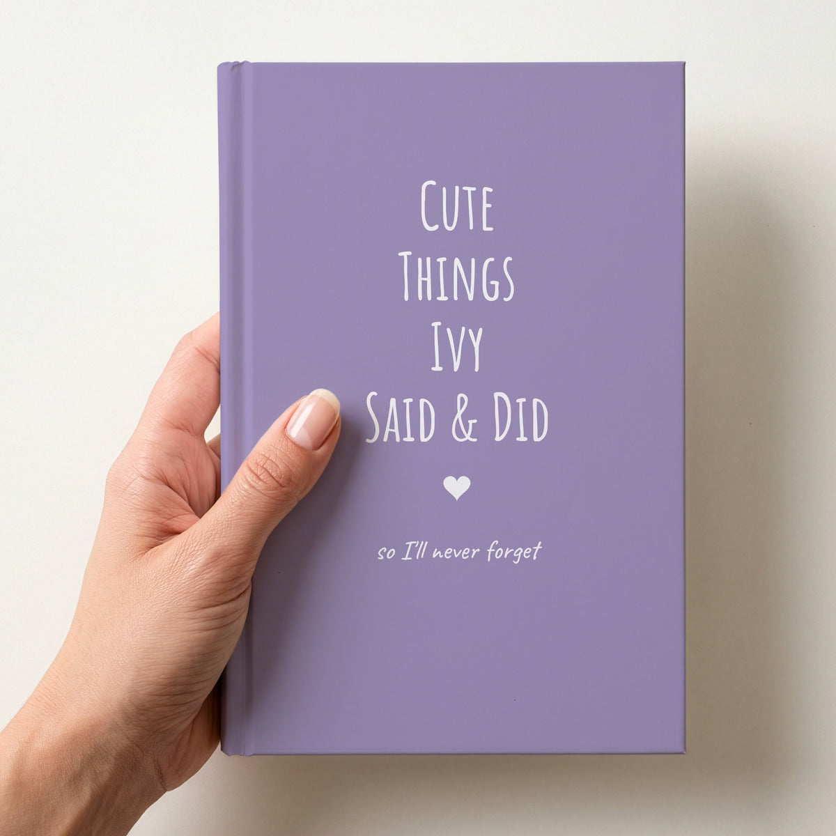 Hand holding a lavender personalised journal reading Cute Things Ivy Said & Did