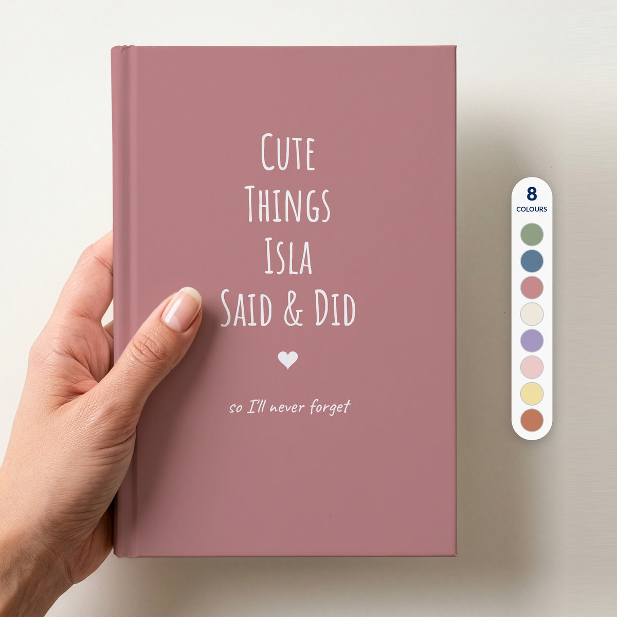 Hand holding a dusty rose personalised journal reading Cute Things Isla Said & Did, beside a column of 8 colour swatches showing all 8 colourways