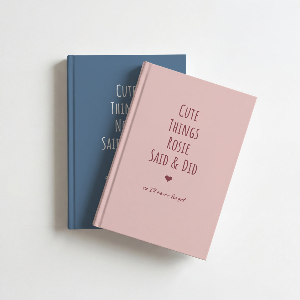 Two Cute Things Said & Did journals, blush pink for Rosie on top of dusty blue for Noah