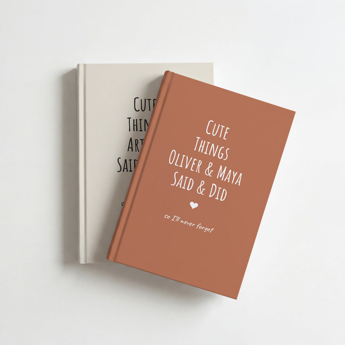 Two Cute Things Said & Did journals, terracotta for siblings Oliver & Maya on top of cream for Arthur