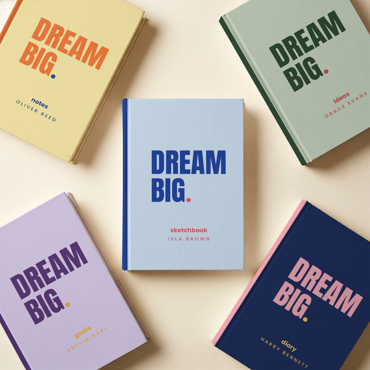 Five personalised 'DREAM BIG.' notebooks in different colourways with different names and cover words