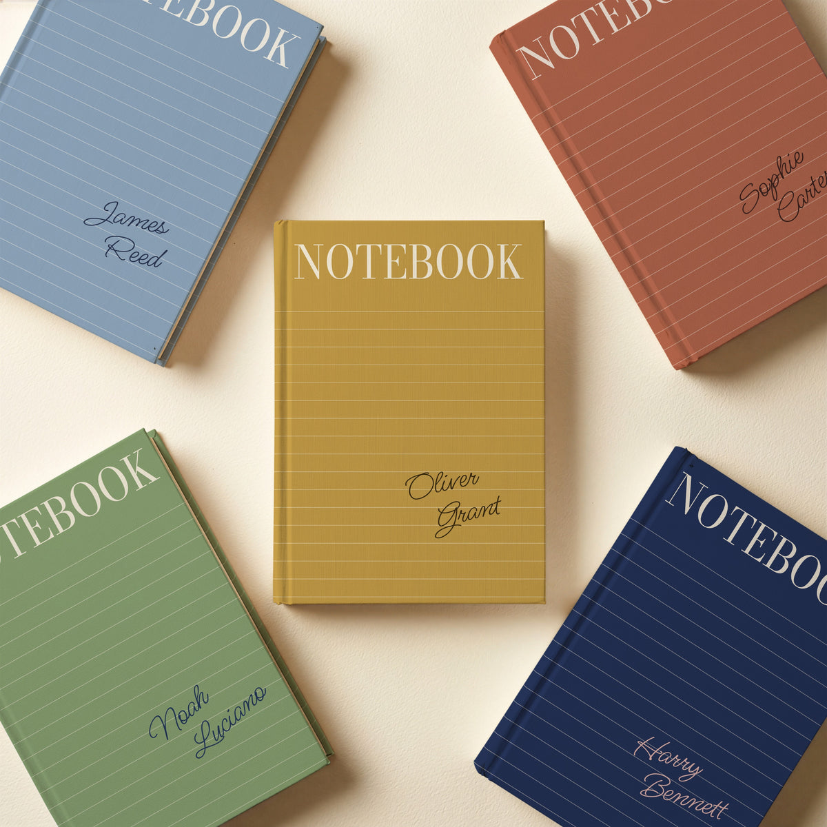 Five lined cover notebooks in terracotta, dusty blue, sage, navy and mustard, each with a name in script