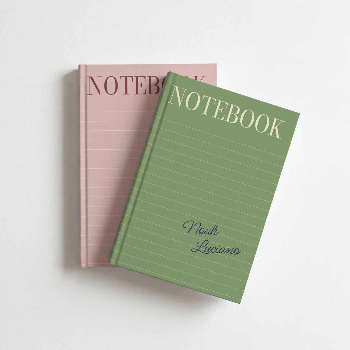 Two lined cover notebooks, sage on top of blush, each with a name in script