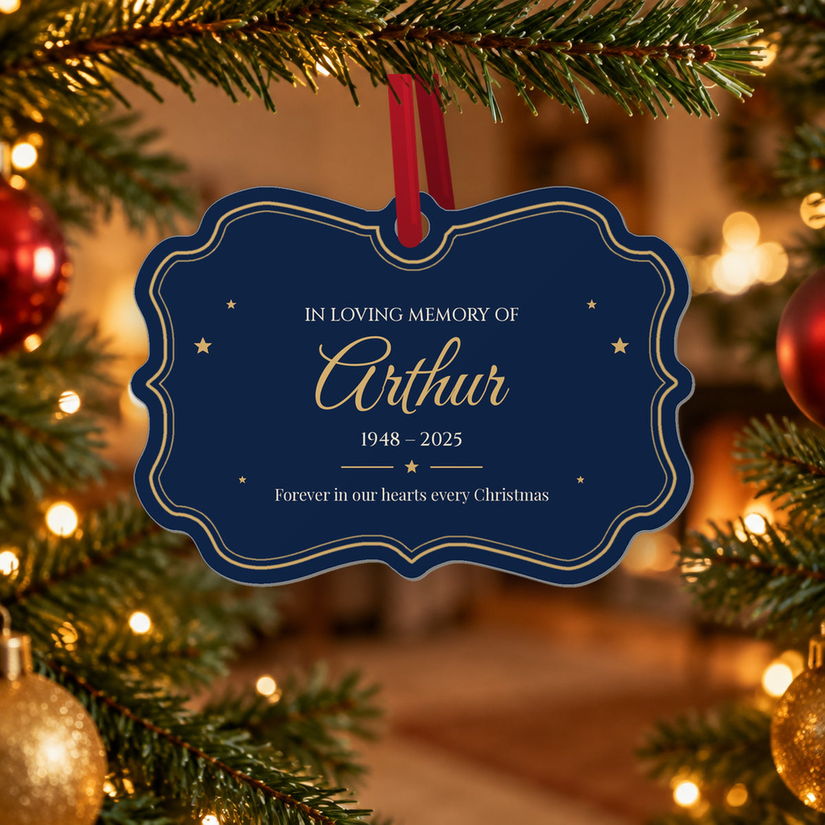 Personalised memorial Christmas ornament for Arthur, 1948 – 2025, navy with a gold scalloped frame, In Loving Memory of and Forever in our hearts every Christmas, hanging on a Christmas tree with warm fairy lights