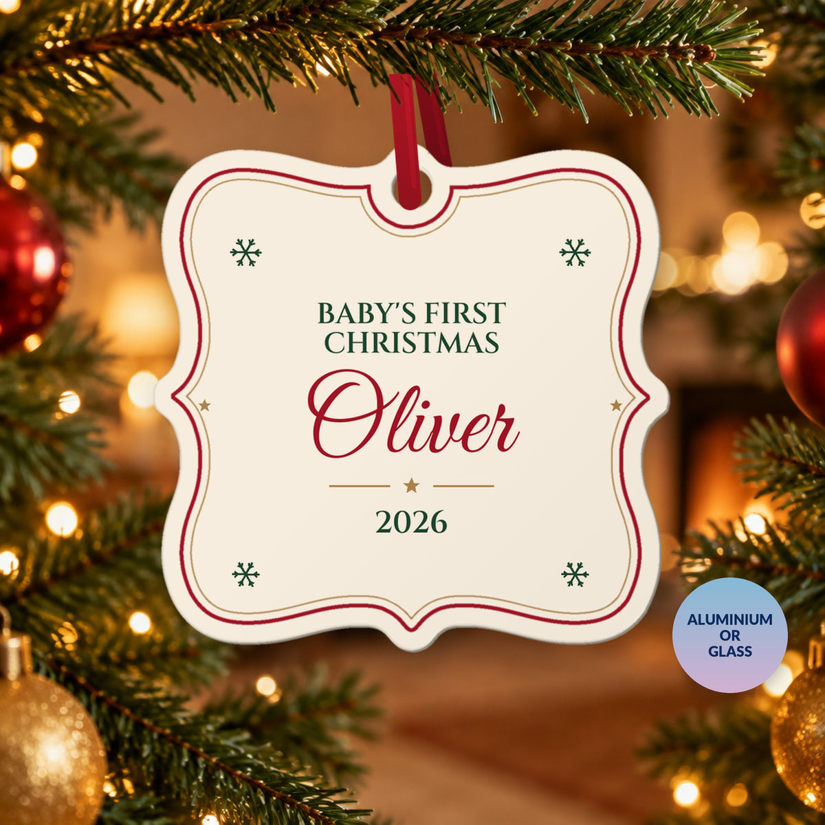 Personalised Baby's First Christmas ornament for Oliver, 2026, white with a red and gold border, hanging on a Christmas tree by a fireplace, with a badge reading Aluminium or Glass